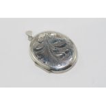 Large sterling silver oval locket with engraved decoration, marked Birmingham 1992