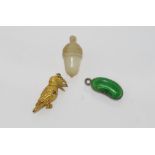 Three vintage charms including 9ct kookaburra , a green enamelled bean charm and a carved Mother