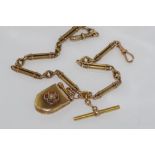 9ct yellow gold fob chain with 9ct & 15ct clasps and 15ct diamond set locket, total weight: approx