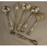 Four kings pattern silver plated ladles together with a butter knife, and a pair of sugar tongs