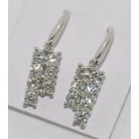 White gold and diamond drop earrings each is set with seven diamonds, the total diamond weight 1