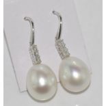 Pair of white gold, pearl and diamond earrings South Sea pearls with three diamonds each, set in