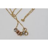 9ct yellow gold chain with tri-colour gold rings weight: approx 2.8 grams