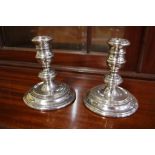 Pair of sterling silver candlesticks hallmarked London 1963, 10.5 cm high