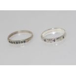 Two silver stone set bands size: approx O/7 with two other rings