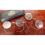 Two pairs of vintage gilt metal spectacles together with a an original leather case