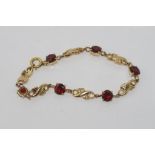 9ct yellow gold and garnet bracelet weight: approx 12.9 grams
