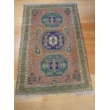 Vintage middle eastern woolen rug in green and brown tones, 173cm X 110cm approx