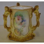 Doulton Burslem loving cup with floral and gilt decoration and cherub figural handles, initialled