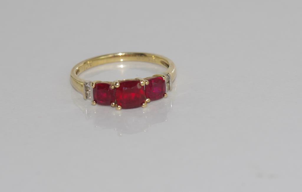 9ct yellow gold and ruby ring (synthetic rubies) with 2 diamonds at each shoulder, weight: approx