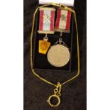 Two Masonic ribbons and a medal together with a 1977 Queen Elizabeth II crown coin pendant and a