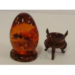 Amber egg on stand together with a carved wooden stand
