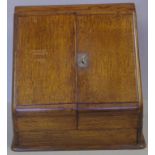 Antique English oak desk top stationery cabinet circa 1880, with two doors opening to reveal a