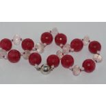 Crystal and red quartz necklace with a silver ball shaped clasp