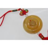 Golden jade pendant on chord