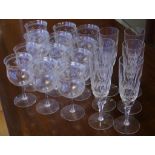 Twelve vintage etched white wine glasses together with 6 cut crystal champagne flutes