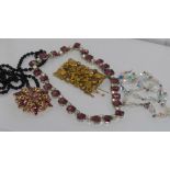 Three vintage necklaces (one with matching earrings) together with two brooches (one missing pin)