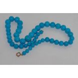 Gradated blue stone necklace with 9ct gold clasp size: approx 54cm length, possibly sleeping