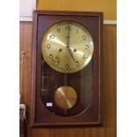 German Emes 1950s wall clock with striking movement, key and pendulum included, 45cm high, 28cm