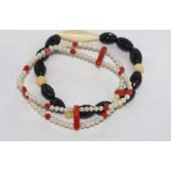 Two various stretch bracelets coral and pearl together with an onyx and ivory