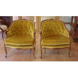 Pair of French Louis XV style bergère chairs with deep buttoned mustard colour upholstery, 71cm