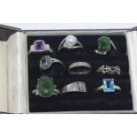 Nine various silver rings in a box (some with markings)