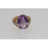 10ct yellow gold and purple stone ring and leaf shaped gold shoulders, unmarked but tested as approx