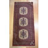 Vintage middle eastern woolen rug in red and cream tones, 142cm X 63cm approx