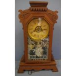 Antique American timber cased mantle clock with 8 day striking movement, together with key and