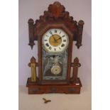 Antique Waterbury mantle clock with 8 day striking movement, key and pendulum included, 55cm high