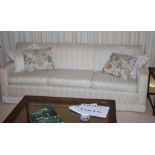 Three seater lounge and two arm chairs in cream upholstery