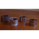 Four vintage napkin rings including sterling silver hallmarked Birmingham 1902 and Sheffield 1906