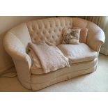 Cream upholstered settee with button back upholstery