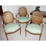 Four French style bridge chairs with green upholstery and wicker backs