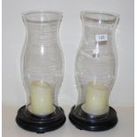 Pair of tall glass storm lamps