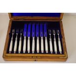 Boxed silver and MOP desert service with sterling silver blades and tines.