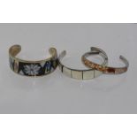 Three silver cuffs set with mother of pearl