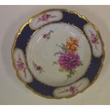 Good antique Meissen soup bowl with blue ground border and panels painted with flowers, 21.8cm