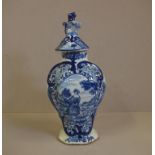 18th century Delft blue & white lidded urn painted Norman figure in cartouche, dog and Fu finial,