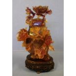 Chinese carved quartz lidded jar on a carved timber stand, 19cm high approx.