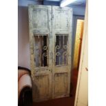 Pair of rustic antique doors of timber and forged iron construction, 219cm high, 48cm wide (each)