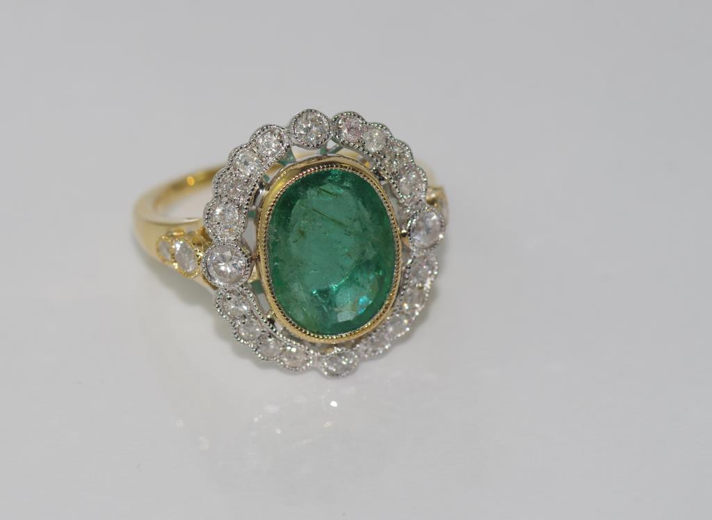 18ct two tone gold, emerald and diamond ring emerald = 3.58 cts, diamonds = 62 pts, weight: approx