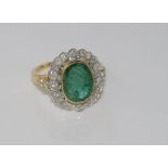 18ct two tone gold, emerald and diamond ring emerald = 3.58 cts, diamonds = 62 pts, weight: approx