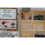 Various unset gemstones including opal jade, tigers eye etc and some gold flakes together with a box