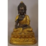 Gilt metal figure of a seated Shakyamuni Buddha on double lotus base. 48cm high.