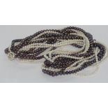 Long multi-strand pearl necklace with silver toggle clasp