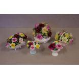 Five floral encrusted china ornaments to include Royal Doulton, Coalport, and Royal Albert