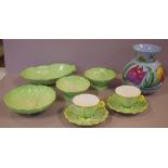 Four green Carlton ware bowls together with 2 English cups and saucers with floral handles and a