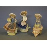 Three Lladro girls with flowers figurines in various poses, 19cm high (tallest)