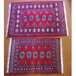 Two small Bokhara wool rugs with red tones, 110cm x 79cm approx (largest)